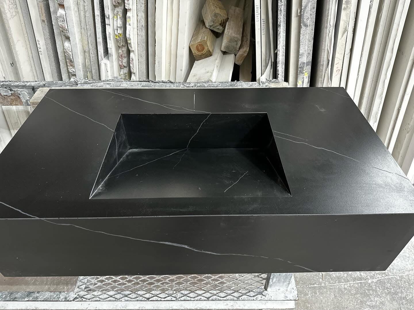 Custom black stone sink and countertop during fabrication in the shop